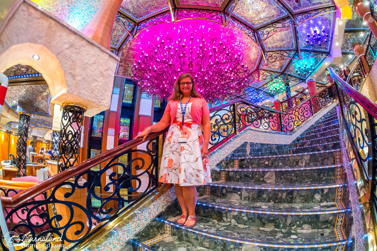 Laura on the stairs in front of the color changing chandelier.