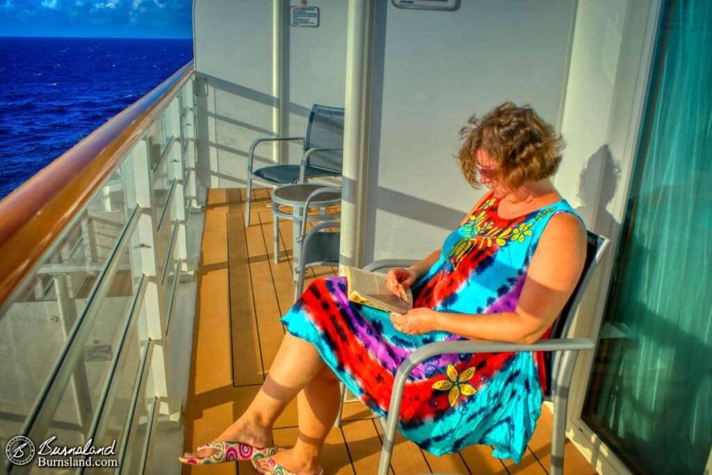 Laura takes some time to read while on our stateroom verandah