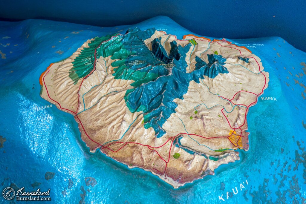 A cool model of the island of Kauaʻi in the visitors center. The lighthouse is near the white words at the upper right of the island.