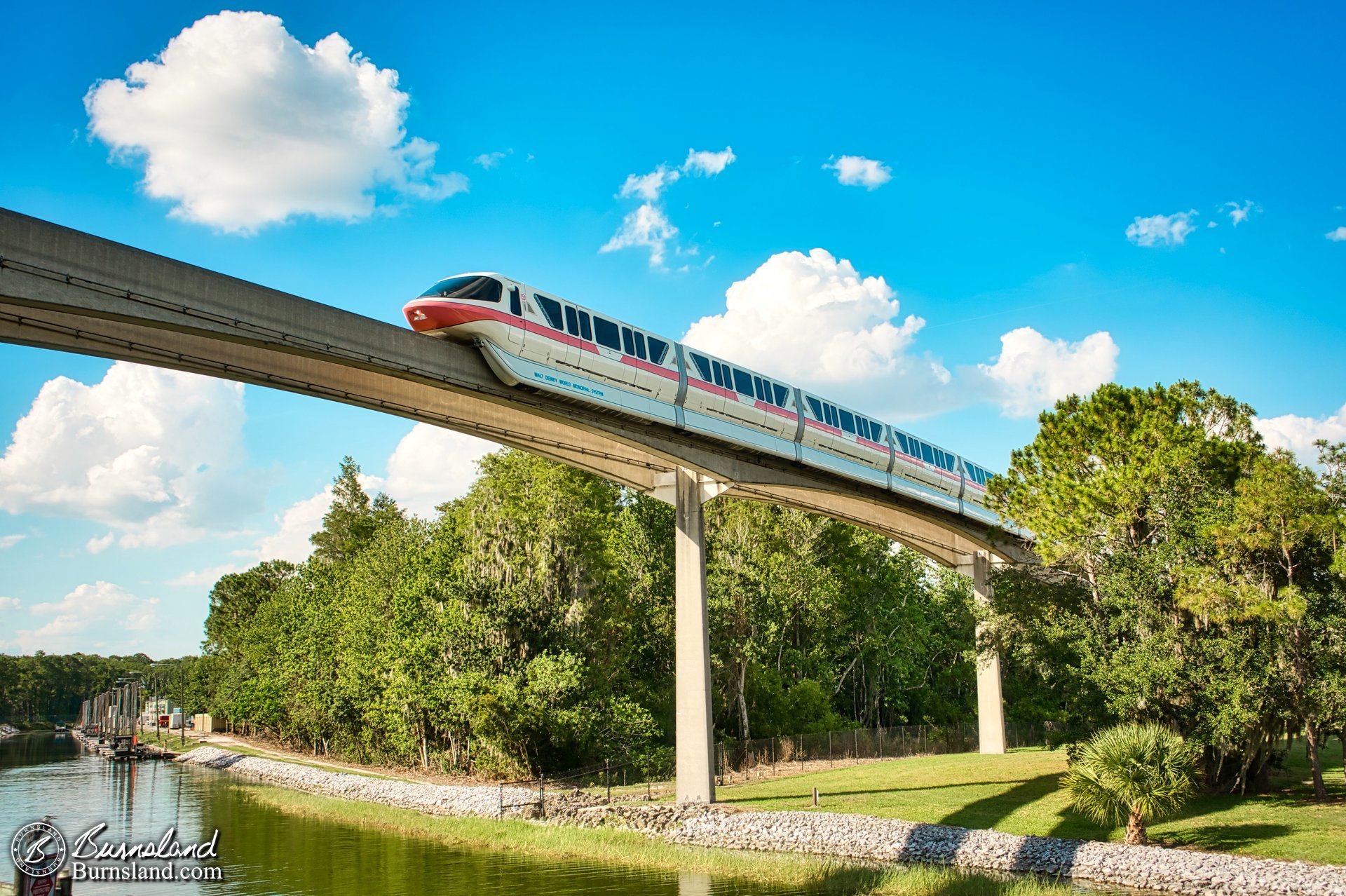 A Monorail crosses the canal that leads to the backstage area of the Magic Kingdom