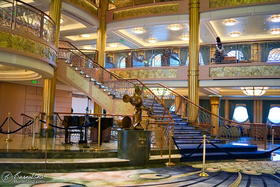 The Disney Fantasy Atrium Lobby, with a statue of Minnie Mouse in the middle