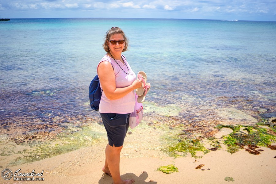 Laura puts her toes in the water at the beach in Cozumel