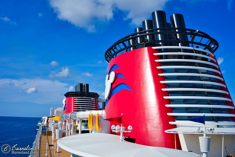 Red funnels of the Disney Fantasy under the Cozumel sun