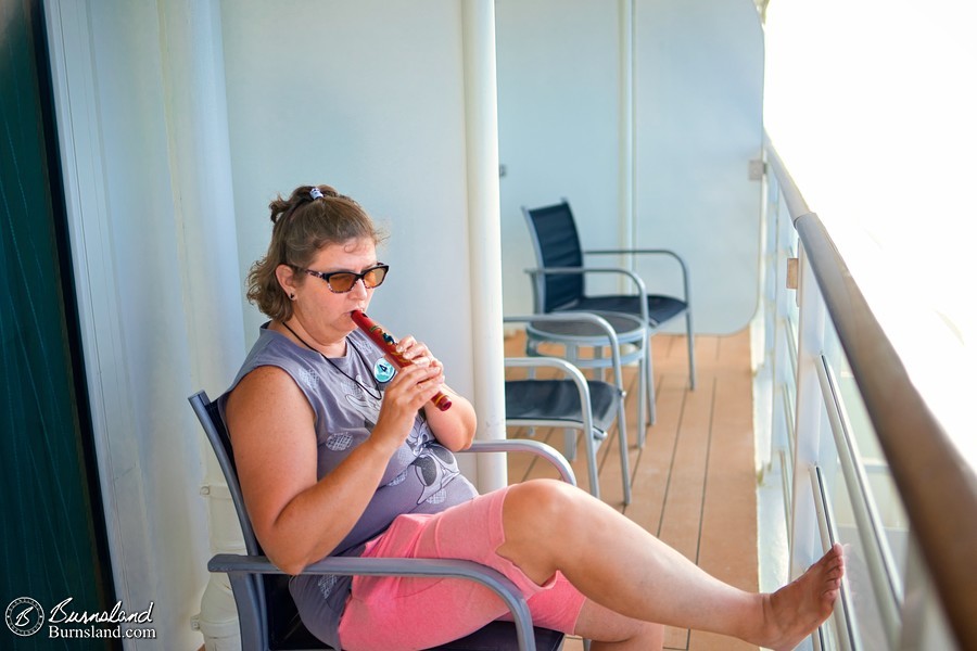 Playing a wooden flute on our verandah on the Disney Fantasy