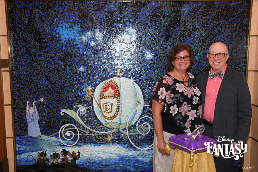 With Cinderella’s glass slipper in front of the Pumpkin Coach mural on the Disney Fantasy