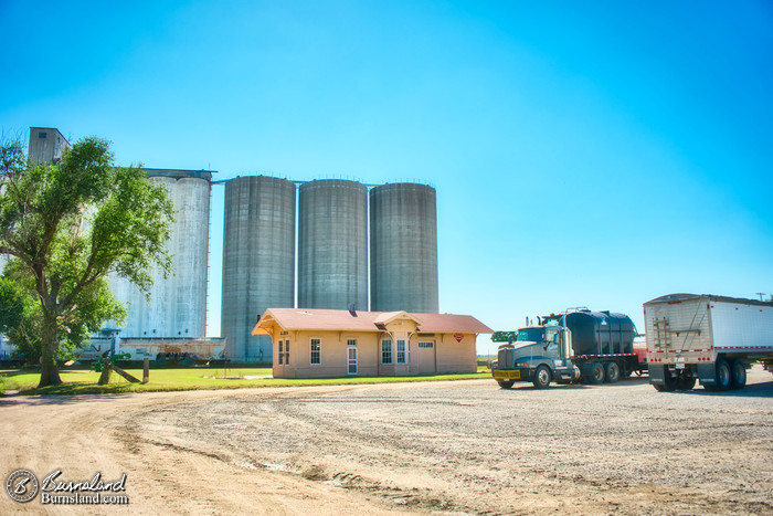 Railroad Depot, grain elevators, and harvesting trucks