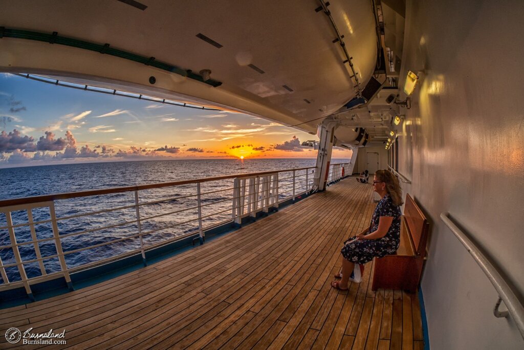 Laura watches the water as the sun sets on the last night of our recent cruise. Read all about it at Burnsland!