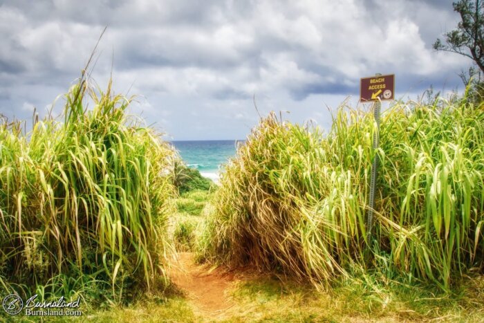 A sign points to beach access as seen during our 2018 Kauaʻi trip, and there are lots of signs telling you things to do these days.