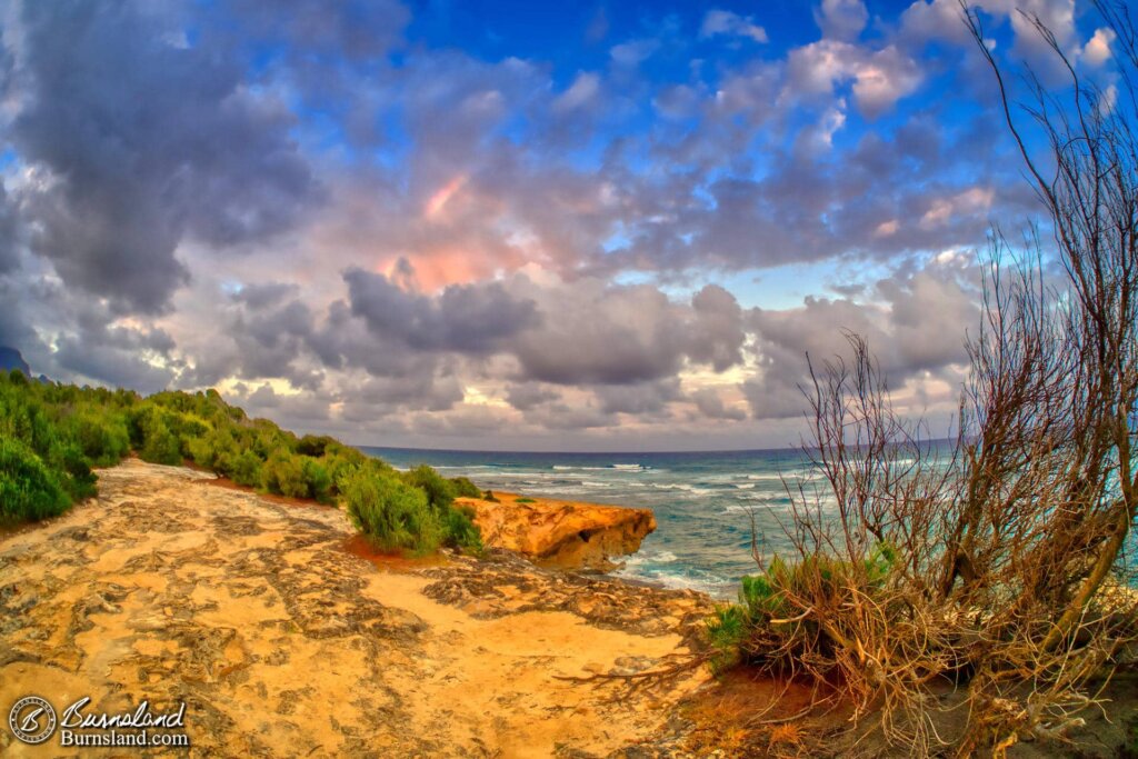 Clouds and a rainbow above Shipwreck Beach on the island of Kauaʻi in Hawaiʻi