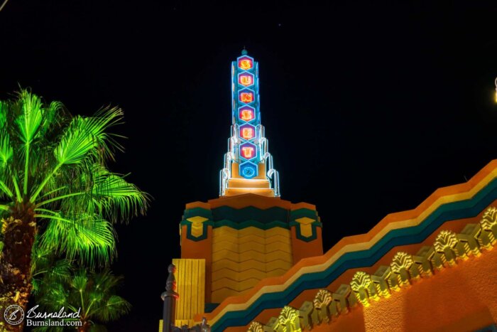 Neon glows at night on the tower of the Beverly Sunset shop on Sunset Boulevard in Disney’s Hollywood Studios at Walt Disney World