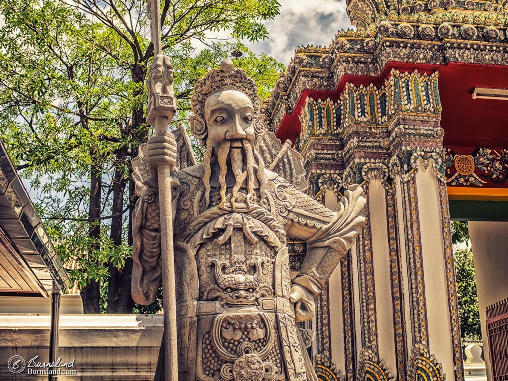 A Chinese warrior figure made out of stone stands guard at the Wat Pho temple complex in Bangkok, Thailand. Read all about it at Burnsland.