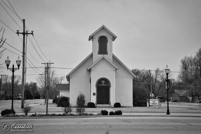 The Church of Christ building in Sterling, Kansas, in black and white on a winter day.