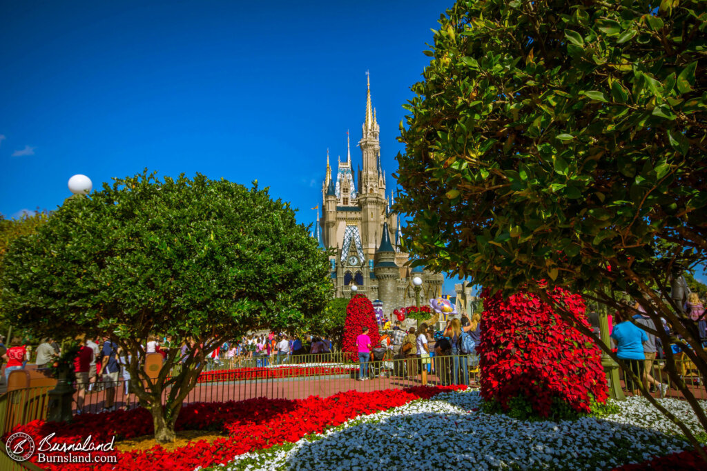 Cinderella Castle at Walt Disney World’s Magic Kingdom surrounded by the holiday colors of red, green, and white