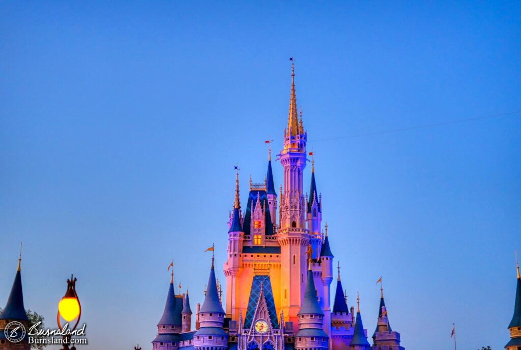 Cinderella Castle glows in the evening hours in the Magic Kingdom at Walt Disney World