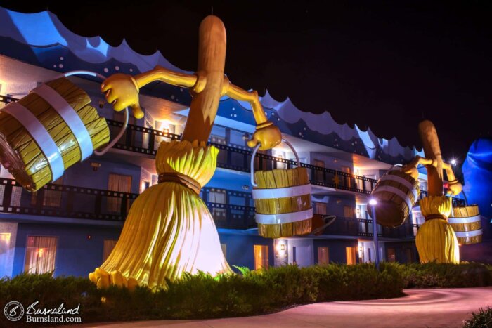 Giant brooms carry water buckets, recreating a scene from The Sorcerer’s Apprentice in Fantasia, as seen at Disney’s All-Star Movies Resort