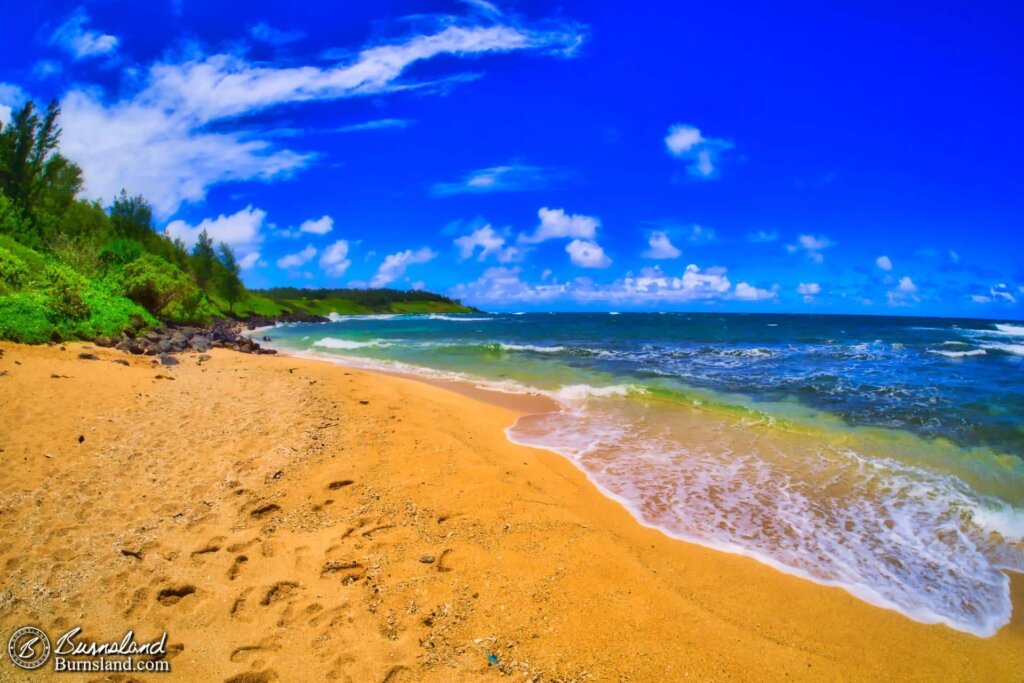 Footprints in the sand at ʻAliomanu Beach on the island of Kauaʻi in Hawaiʻi