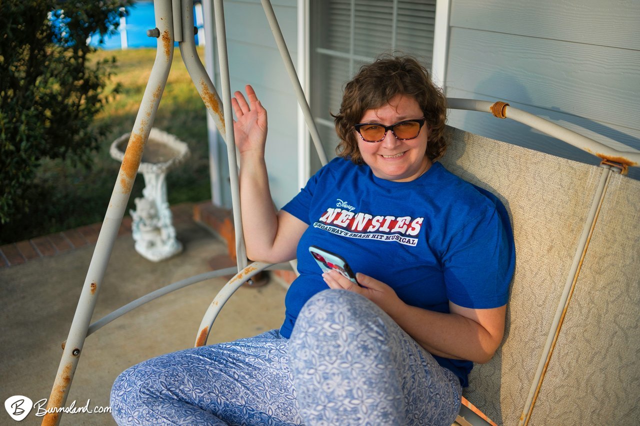 A close-up view of Laura in the front porch swing