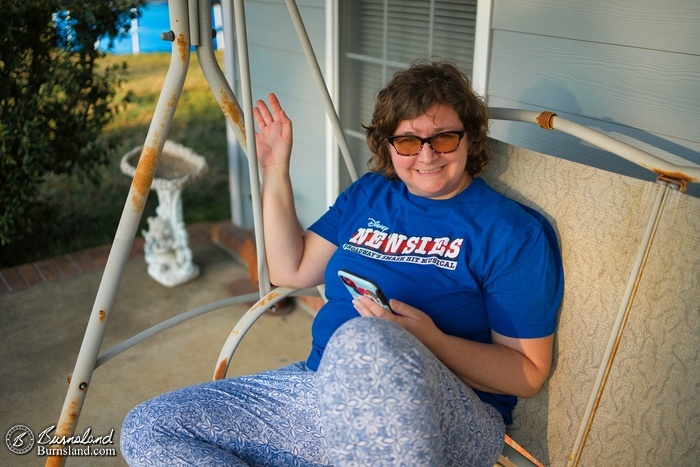 A close-up view of Laura in the front porch swing