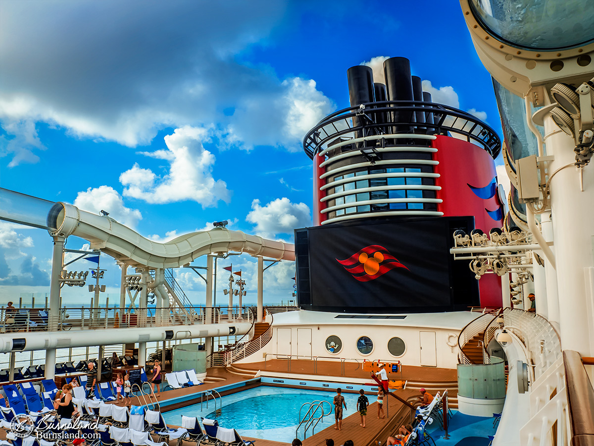 The Disney Cruise Line logo is displayed on the large Funnel Vision screen before a movie is shown on the Disney Dream cruise ship. Read all about it at Burnsland!