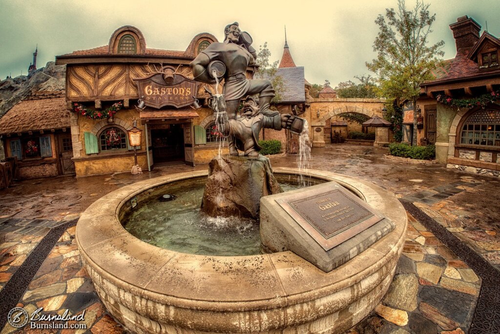 A statue of Gaston and LeFou stands outside of Gaston’s Tavern in Fantasyland in Walt Disney World’s Magic Kingdom.