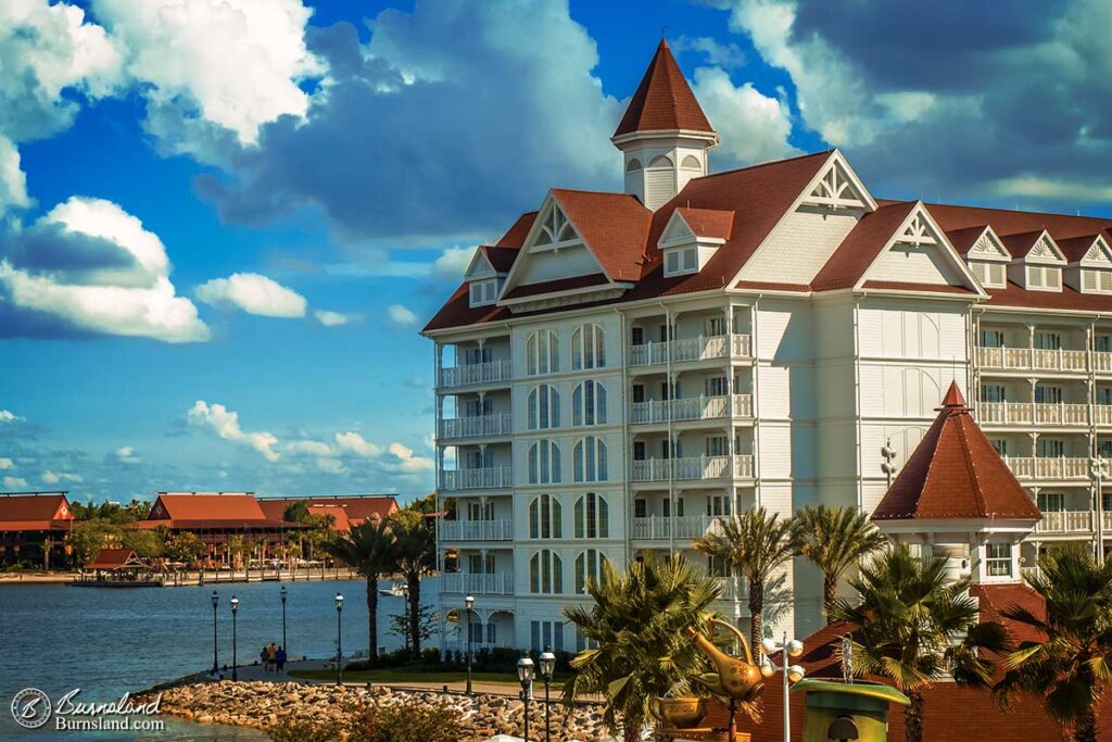 The Grand Floridian Resort stands tall in the foreground with the Polynesian Village Resort off in the distance at Walt Disney World in Florida. Read all about it at Burnsland!