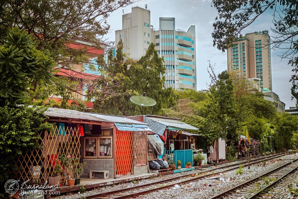 Makeshift homes are found along railroad tracks in Bangkok, Thailand. Read all about it at Burnsland!