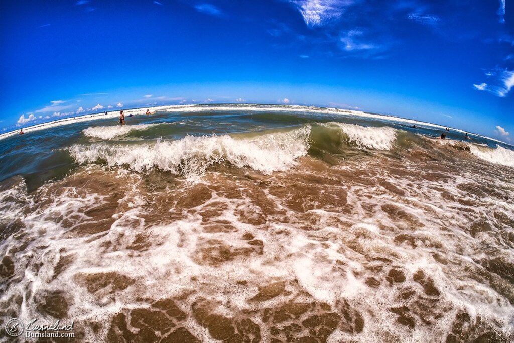 Waves in the Atlantic Ocean curl and crash near the shore at Cocoa Beach, Florida. Read all about it at Burnsland!