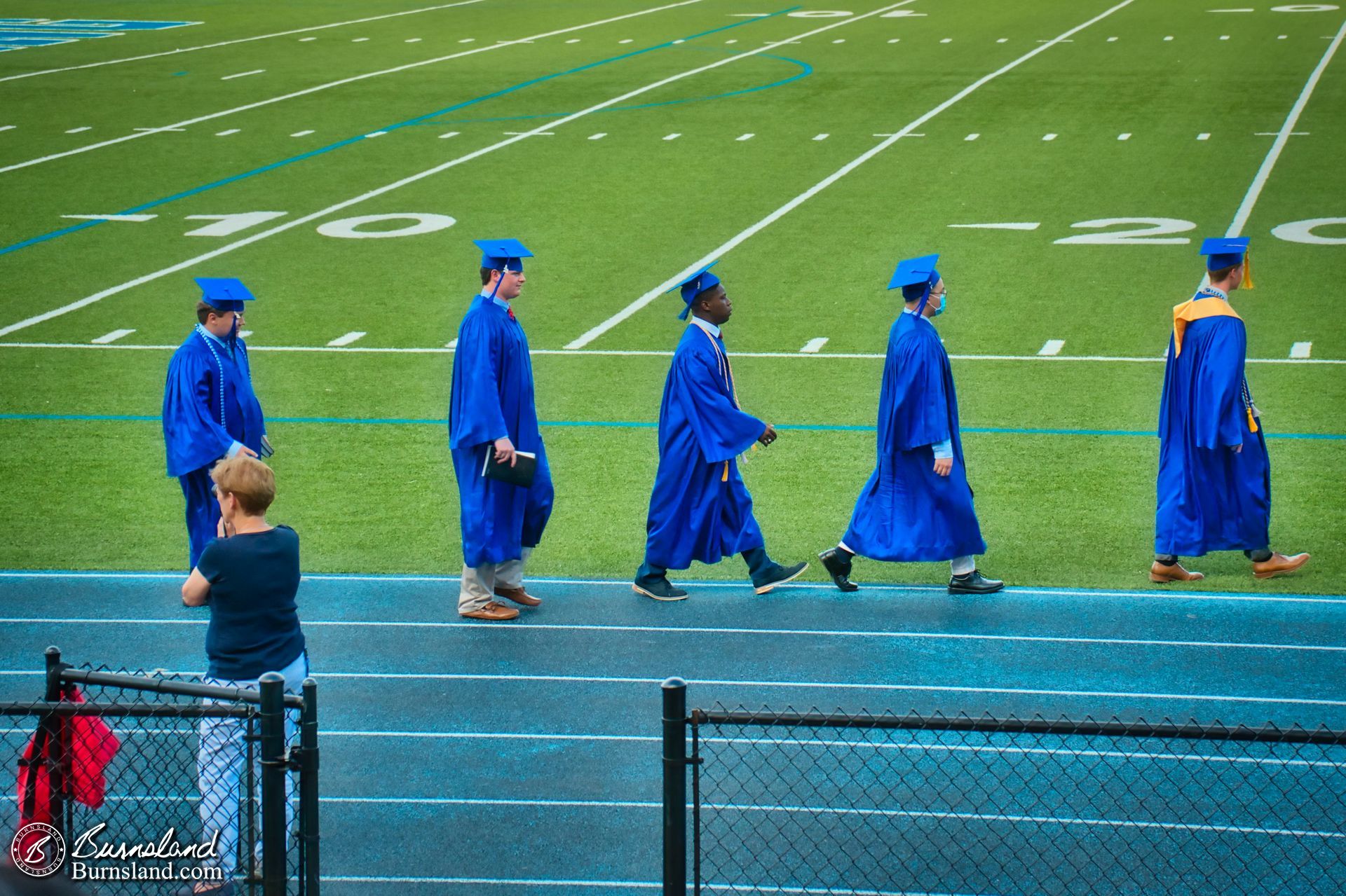 Jaylin and his classmates walk in to the graduation ceremony