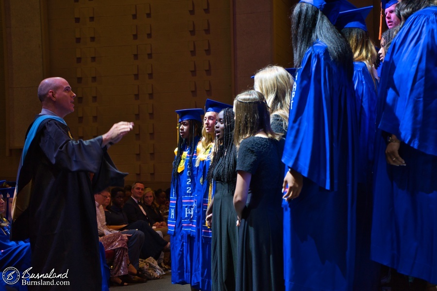 Katie sings with the chorus at her high school graduation