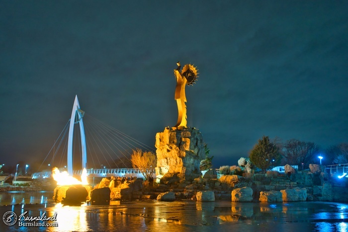 The Keeper of the Plains reflects the light of the nearby Ring of Fire at night, as seen during our recent visit to Wichita, Kansas.