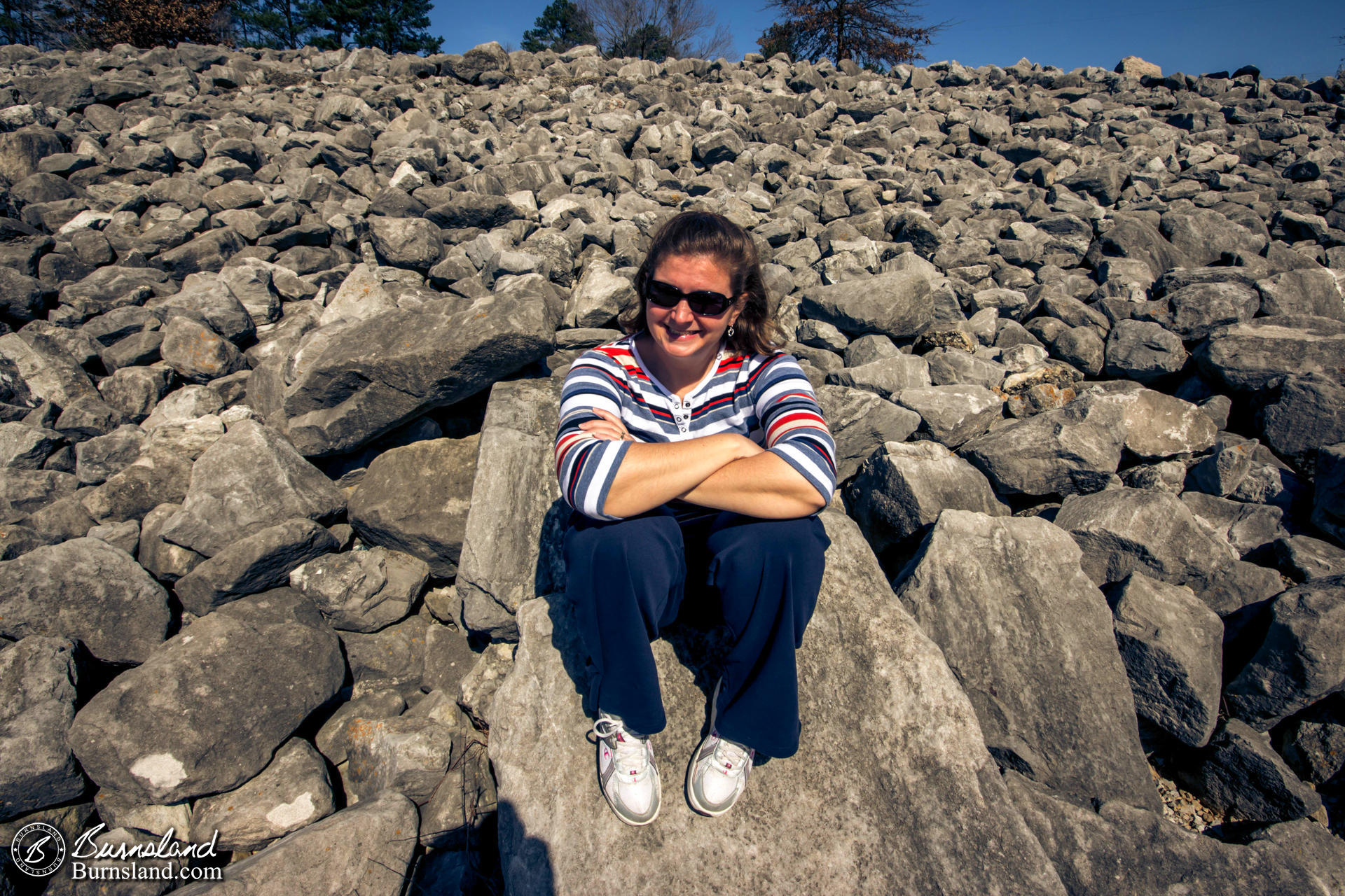 Laura sits on the rocks near the Pickwick Landing Dam on the Tennessee River