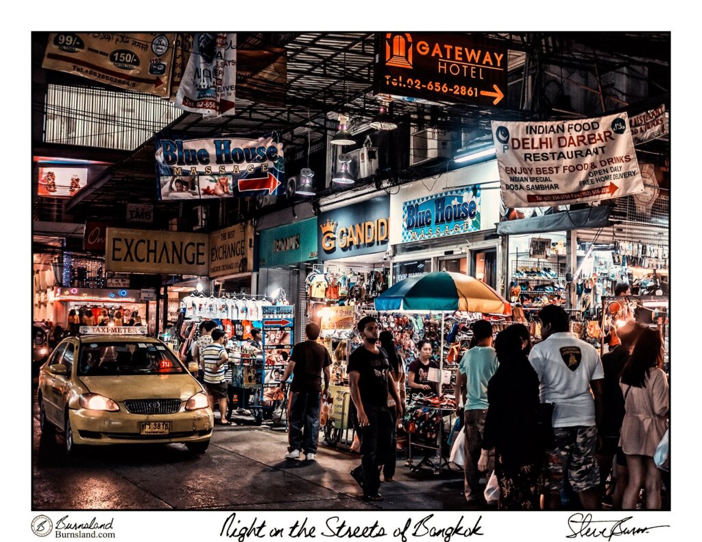 People walk, drive, and shop at night in the streets of Bangkok, Thailand. Read all about it at Burnsland.