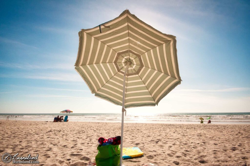 Our beach umbrella blocks the sun from view in this old photo from our 2011 visit to Cocoa Beach in Florida.