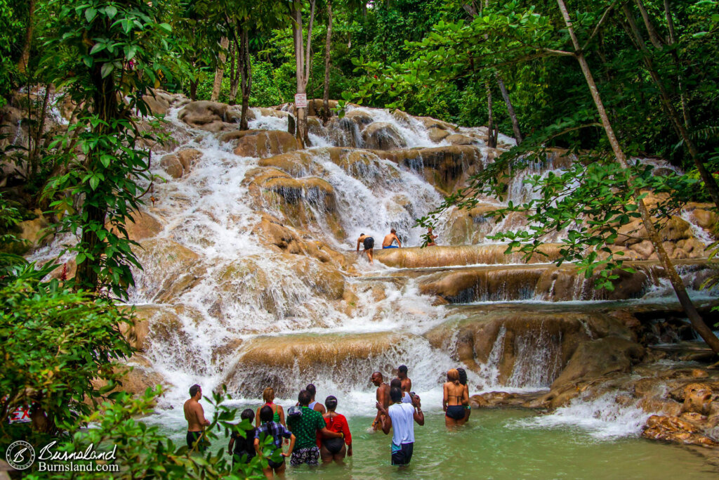 People wait to climb the waterfall at Dunn’s River Falls in Jamaica