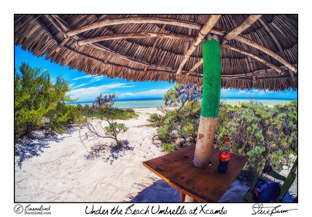 Enjoying the shade of an umbrella while on a perfect beach in Mexico, with a Coca-Cola with real sugar for some refreshment. Read all about it at Burnsland!