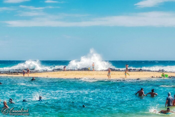 Waves crash onto the shore at Poʻipū Beach Park on the island of Kauaʻi in Hawaiʻi