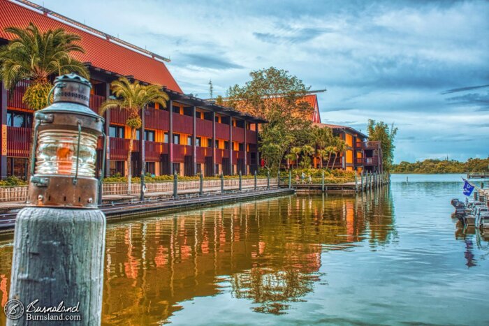 The Fiji and Tuvalu buildings of the Polynesian Village Resort are reflected in the waters of Seven Seas Lagoon at Walt Disney World