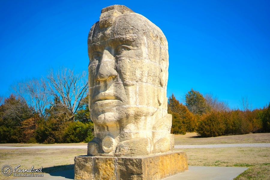 A large stone “Ancient Man” statue by artist Stan Herd in a park in Parsons, Kansas