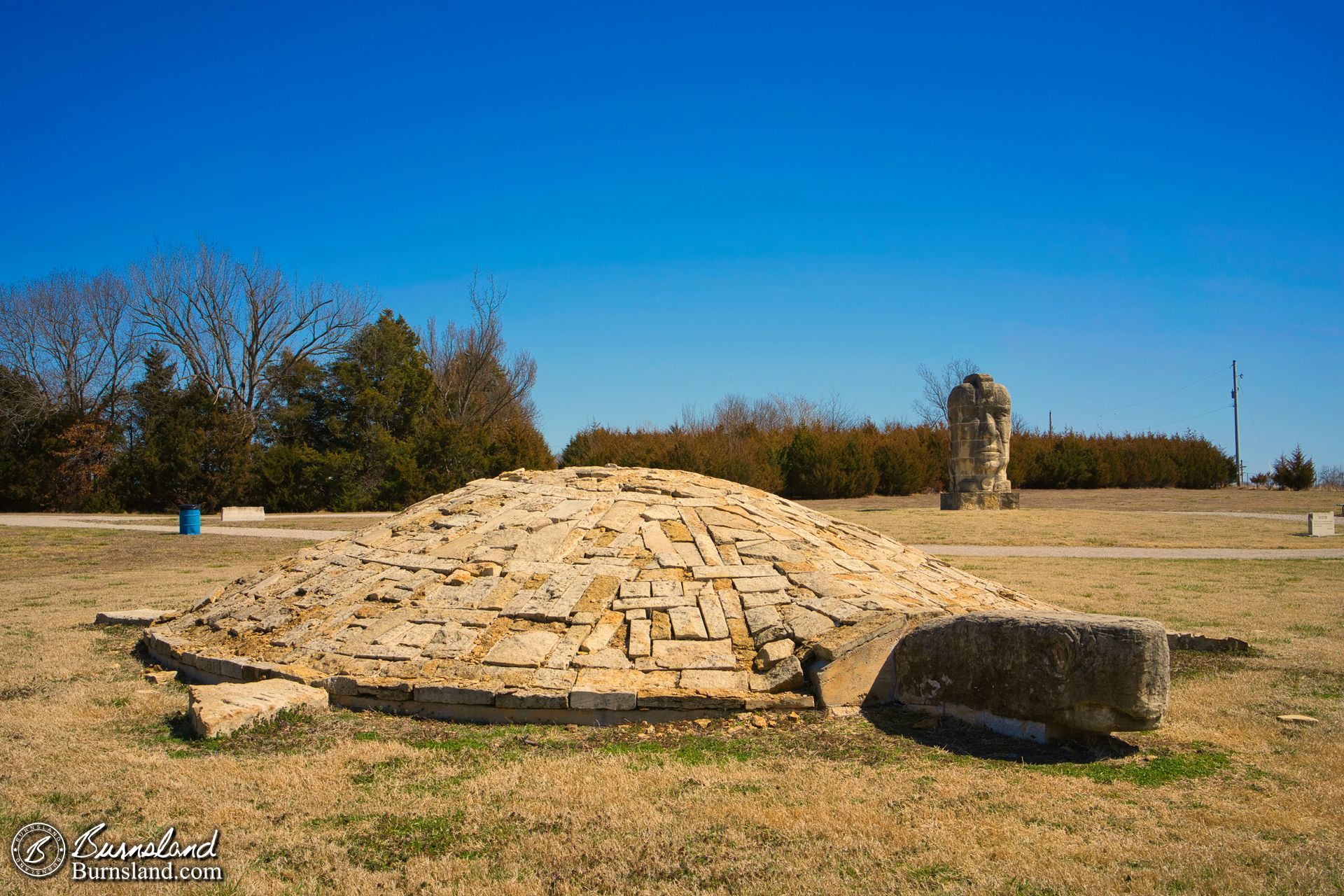 Large stone “Ancient Man” and “Turtle Island” sculptures by artist Stan Herd are found in a park in Parsons, Kansas.