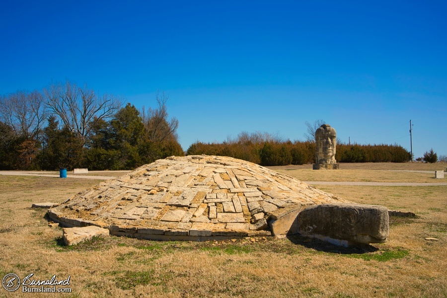 Large stone “Ancient Man” and “Turtle Island” sculptures by artist Stan Herd are found in a park in Parsons, Kansas.