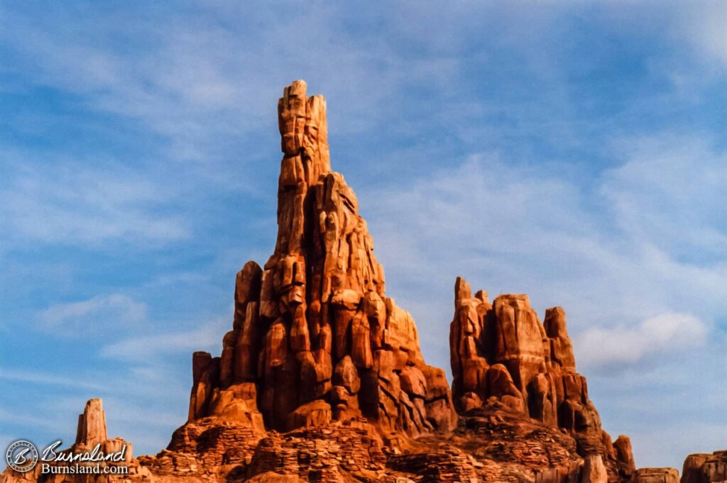 The Florida sun highlights the spires of Big Thunder Mountain on a bright summer day.