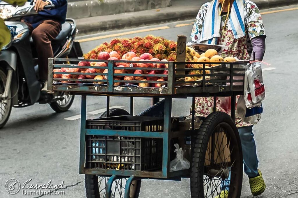 In the morning hours, street vendors roll their carts along the roadway to where they will set up shop for the day in Bangkok, Thailand. Read all about it at Burnsland!