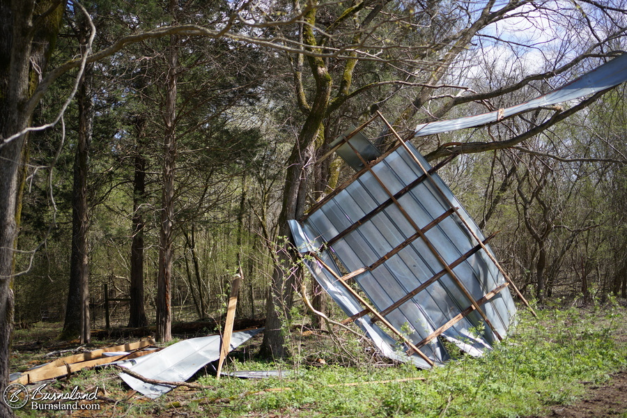 The barn roof in a tree and on the ground