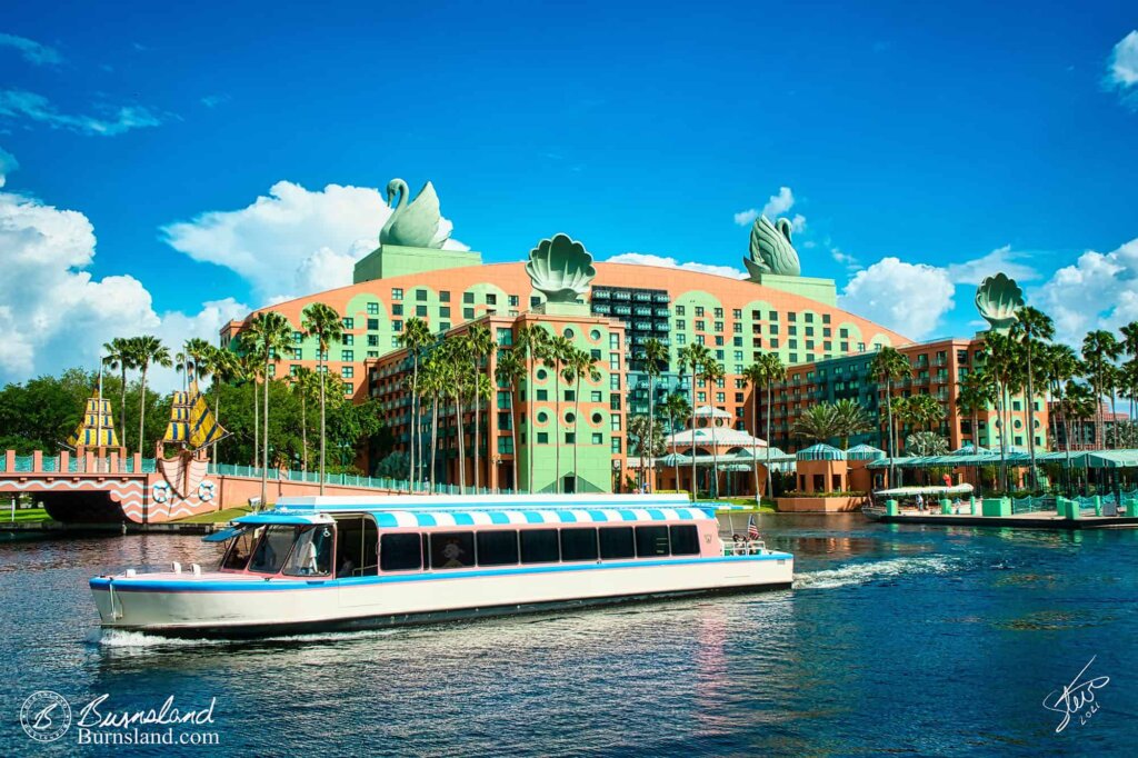 A Friendship boat passes in front of the Walt Disney World Swan hotel in Florida, as seen during our 2021 Florida Trip. And there might be a special passenger on board.